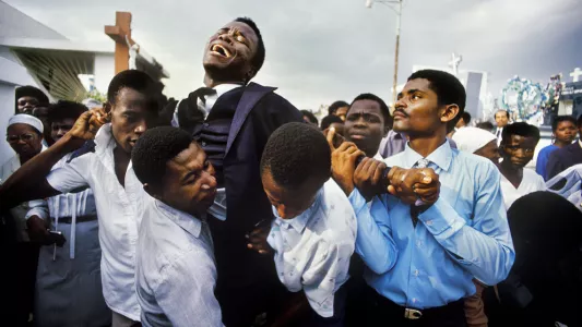 Maggie Steber.  This photo shows a young Haitian man grieving at the funeral of his mother in Port-au-Prince in 1987. Steber has documented Haiti for more than 30 years.